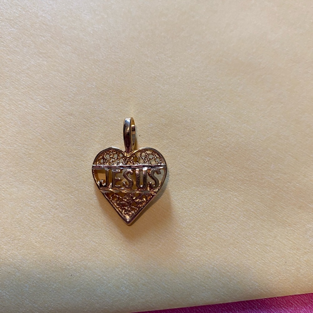 Heart charm with “Jesus” on the front